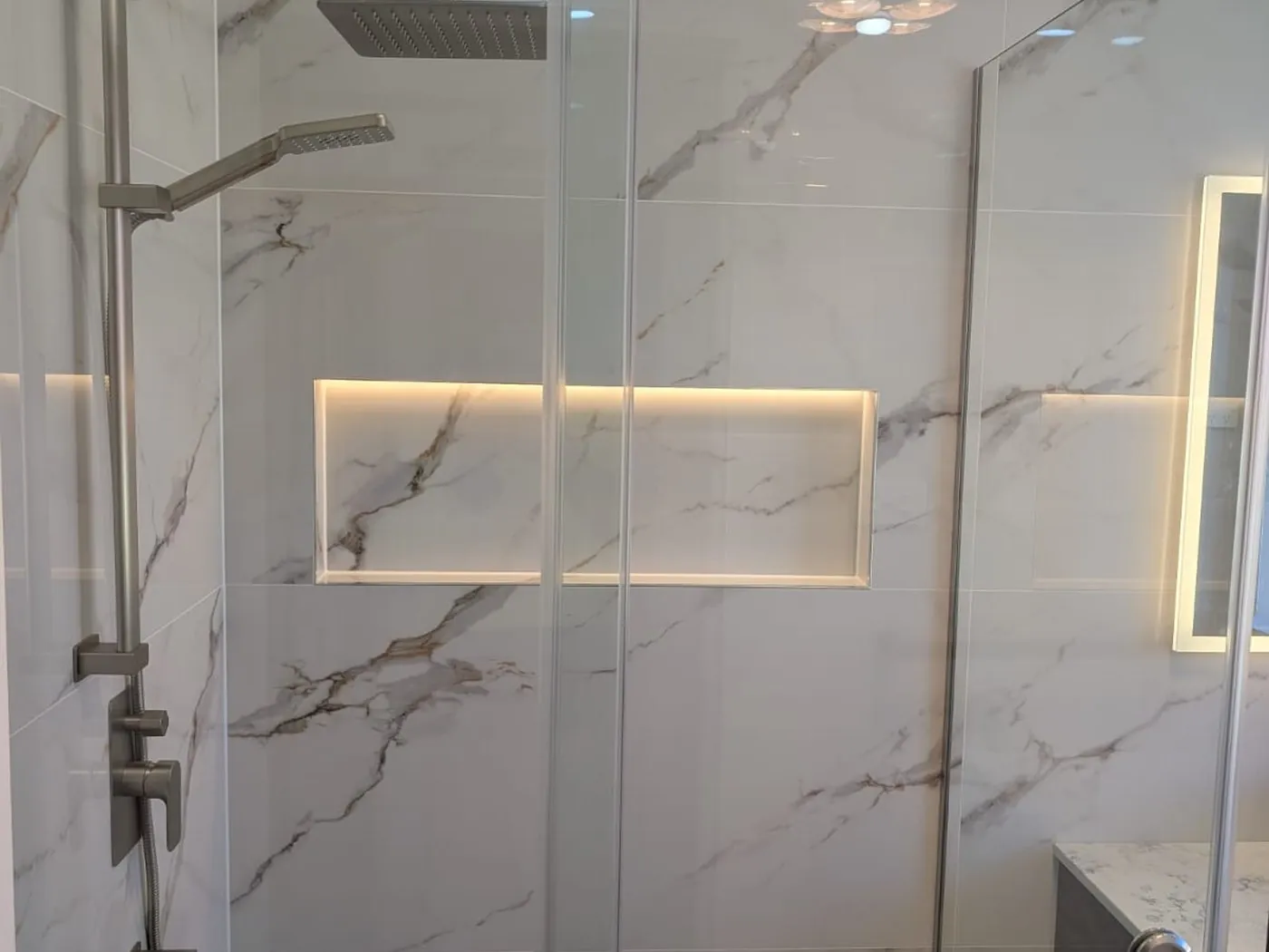 Quakers Hill bathroom renovation with marble-look tiling, timber vanity and frameless shower