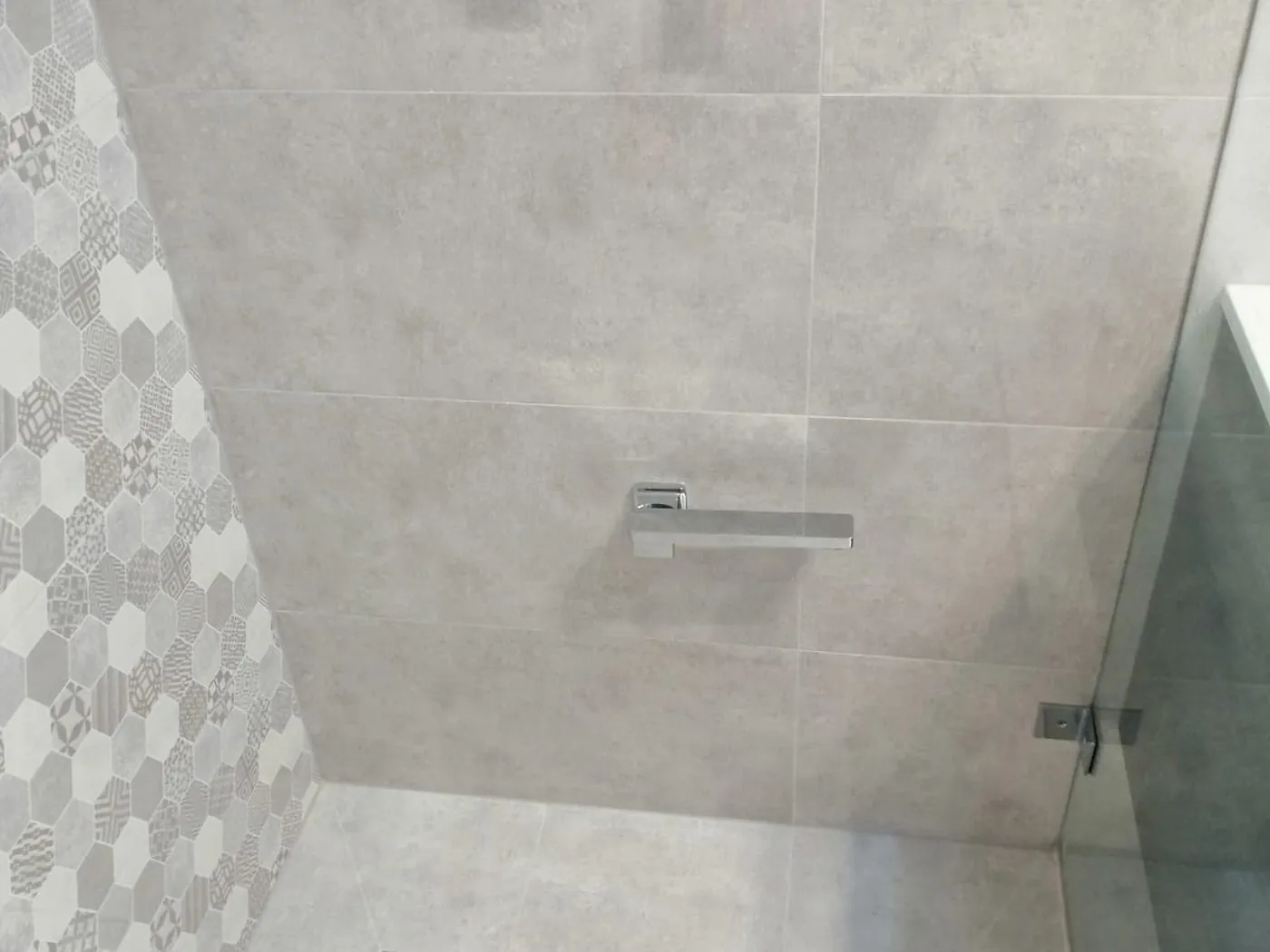 Minto bathroom renovation with hexagon feature tiles, concrete-look walls and walk-in shower
